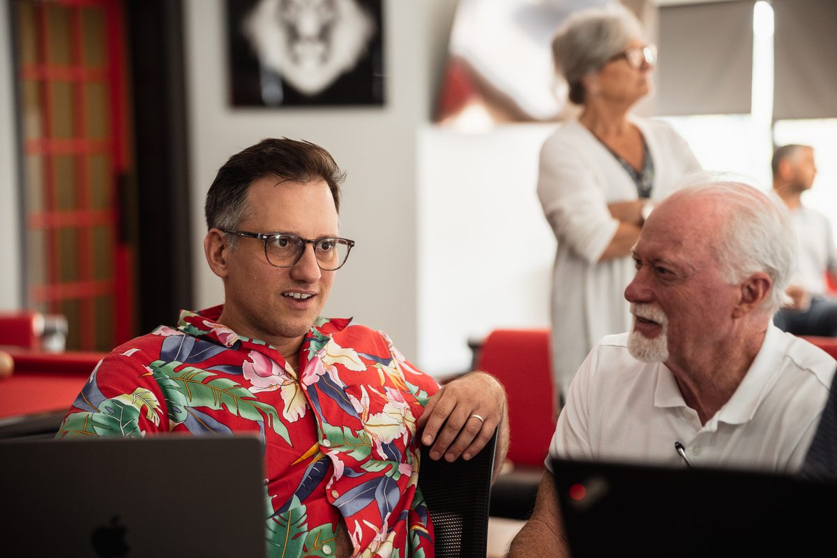 Two members comparing notes during a session