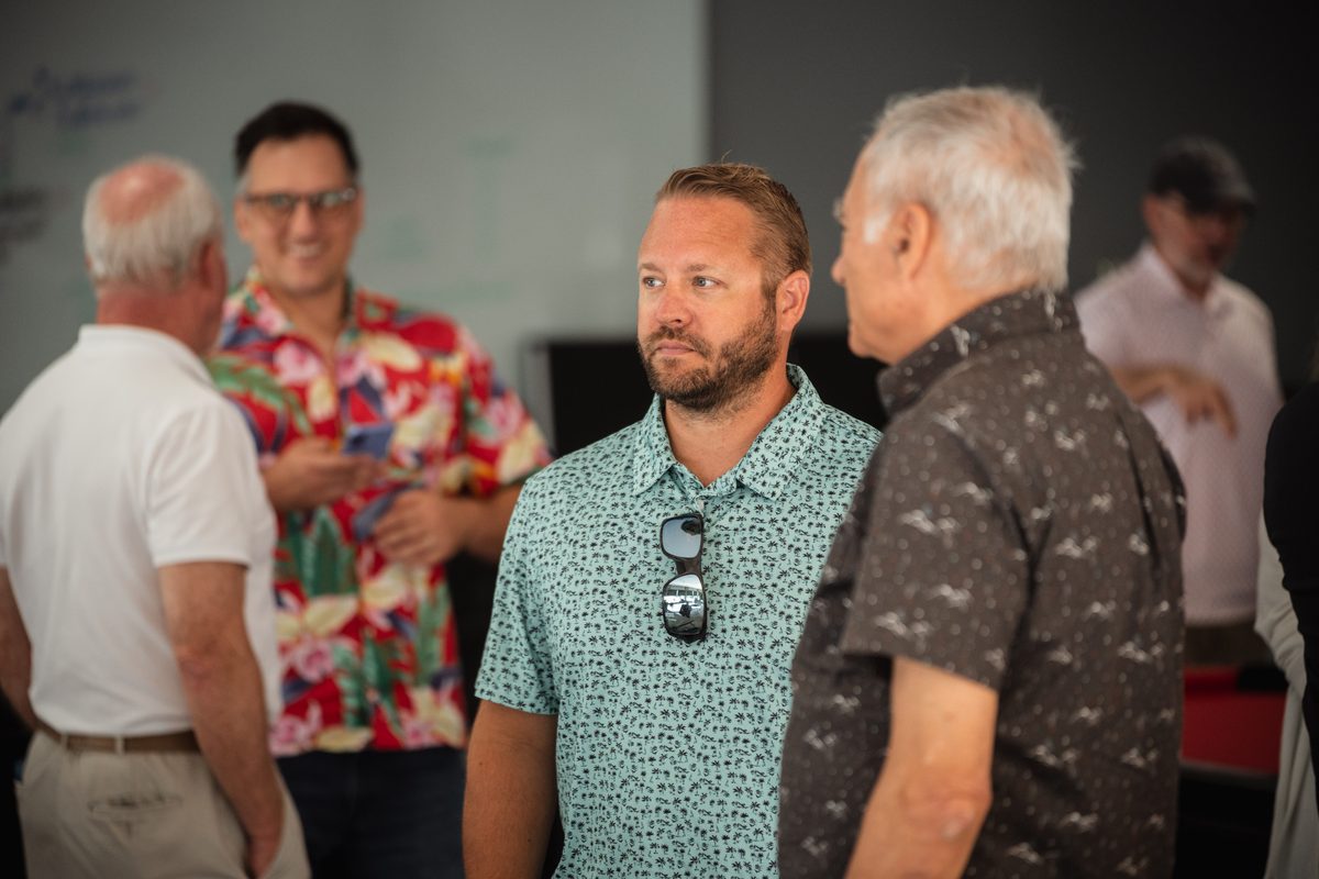 Members talking in a group after the board is worked