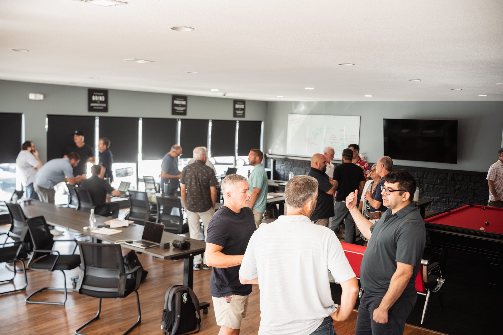 Members networking in the second-floor meeting space at a GEMS session